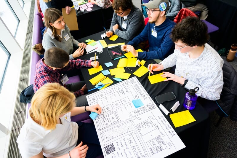 Students sitting around a table at Leading Scholar