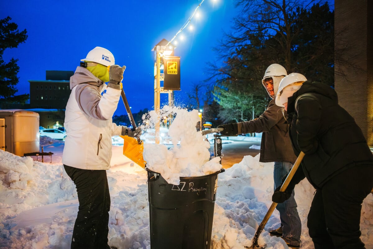 Students making slush in a garbage can during Winter Carnival