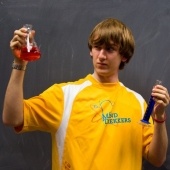 Mind Trekkers student holding up a beaker.