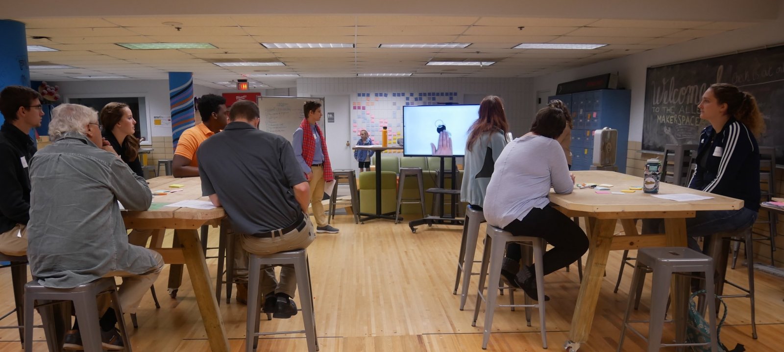 Group of people watching a presentation in the makerspace.