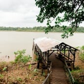 wooden covered boat dock on a river in Suriname
