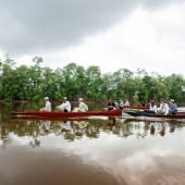 students in canoes on the river in suriname