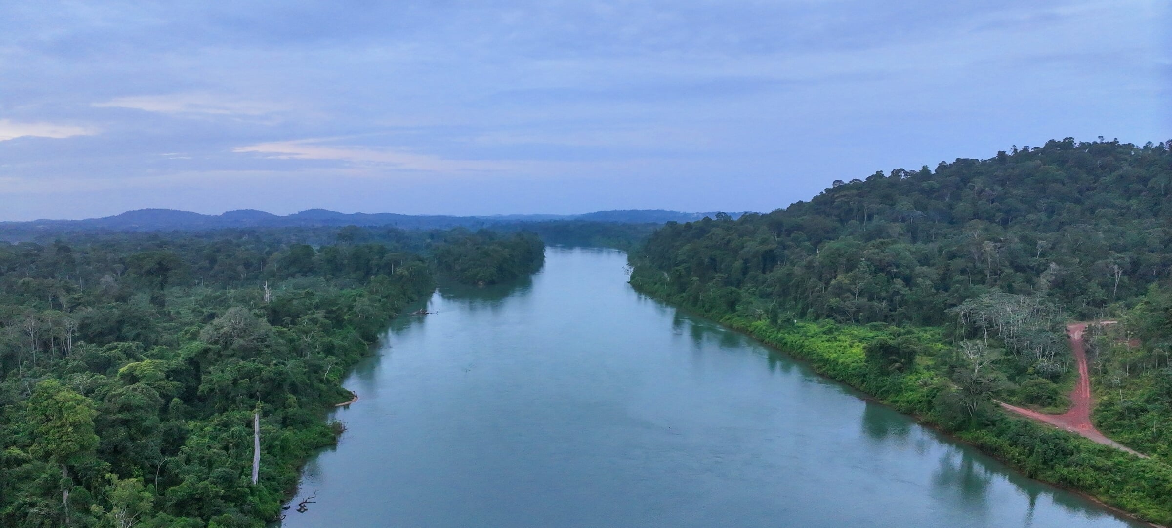 View of the Amazon Basin in Suriname, featuring a waterway in the venter with green forests on either side