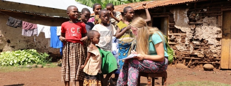 Female student working with children in Africa.