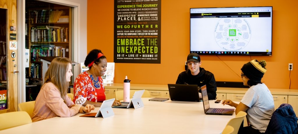 Students and Advisors sitting around a table in the Pavlis Honors College collaboration space.