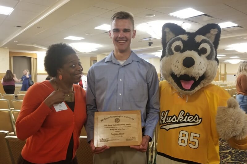 A photo of a faculty member, student, and the Michigan Tech mascot