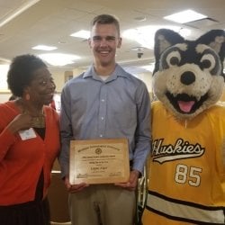 A photo of a faculty member, student, and the Michigan Tech mascot