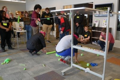 Students engaged in a blindfolded obstacle course