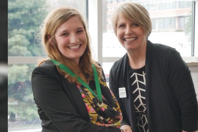 Shelby Marter shakes hands with the dean