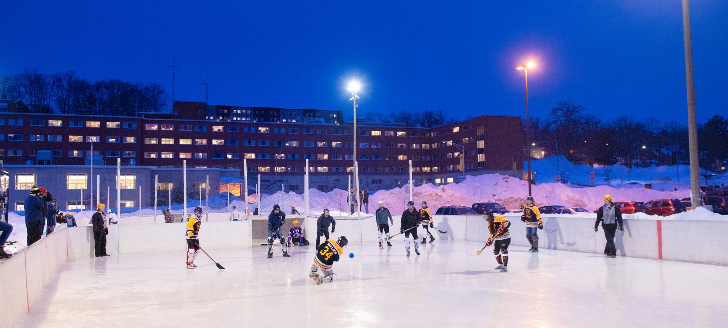 A broomball match at dusk