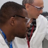 Two researchers in lab coats looking away from the camera.