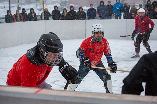 Broomball players in red jerseys