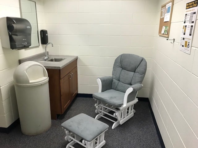 MEEM lactation space with a chair, ottoman, sink, and trash can.