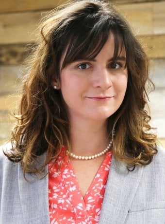 Portrait of Trish in a gray jacket and pink blouse.