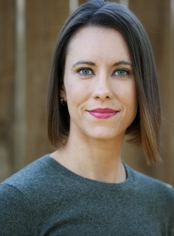 Portrait of Jennifer in a blue sweater.