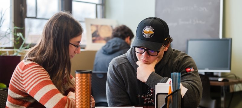 Students sitting at a table in the Multiliteracies Center