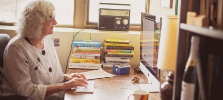 Faculty in office doing research online