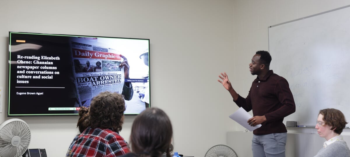 RTC student Eugene Agyei presents his research on Ghanaian journalist Elizabeth Ohene to peers and professor Laura Fiss.