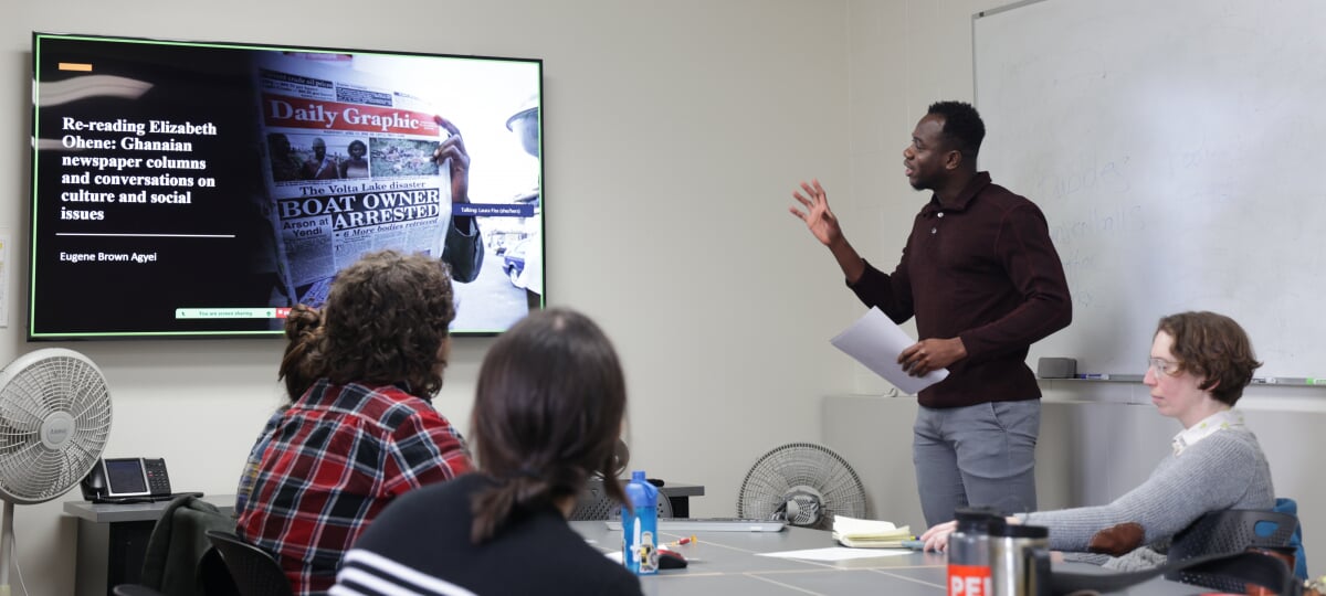 RTC student Eugene Agyei presents his research on Ghanaian journalist Elizabeth Ohene to peers and professor Laura Fiss.