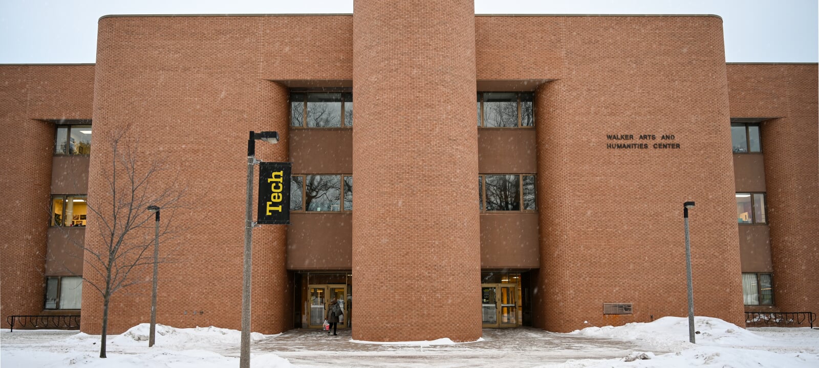 View of the front of Walker Arts & Humanities Center with snow on the ground.