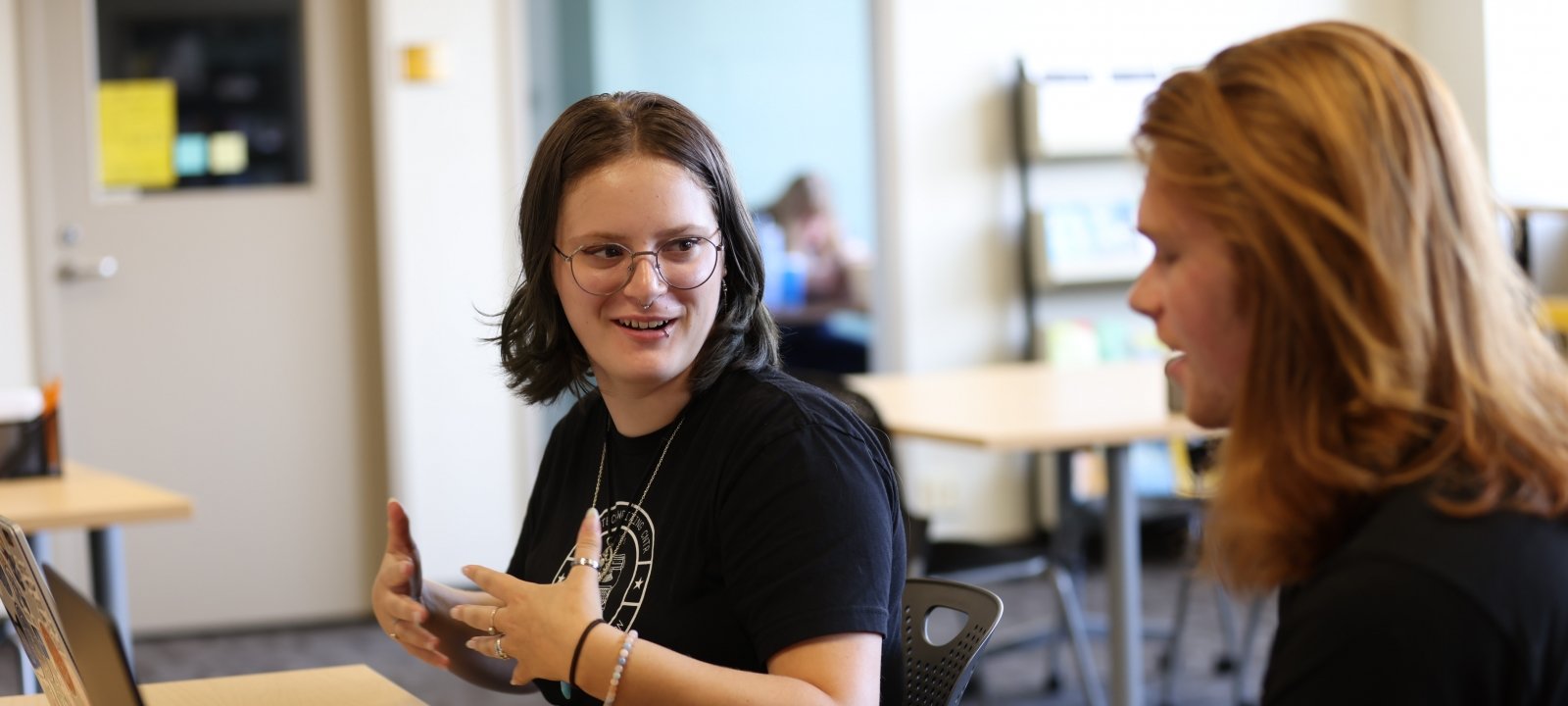 A tutor in the Michigan Tech Writing Center works with a student on a writing assignment.