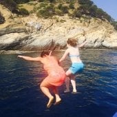 Two students jumping into the water in Barcelona