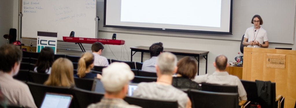 Audience listens to a lecture from a faculty member