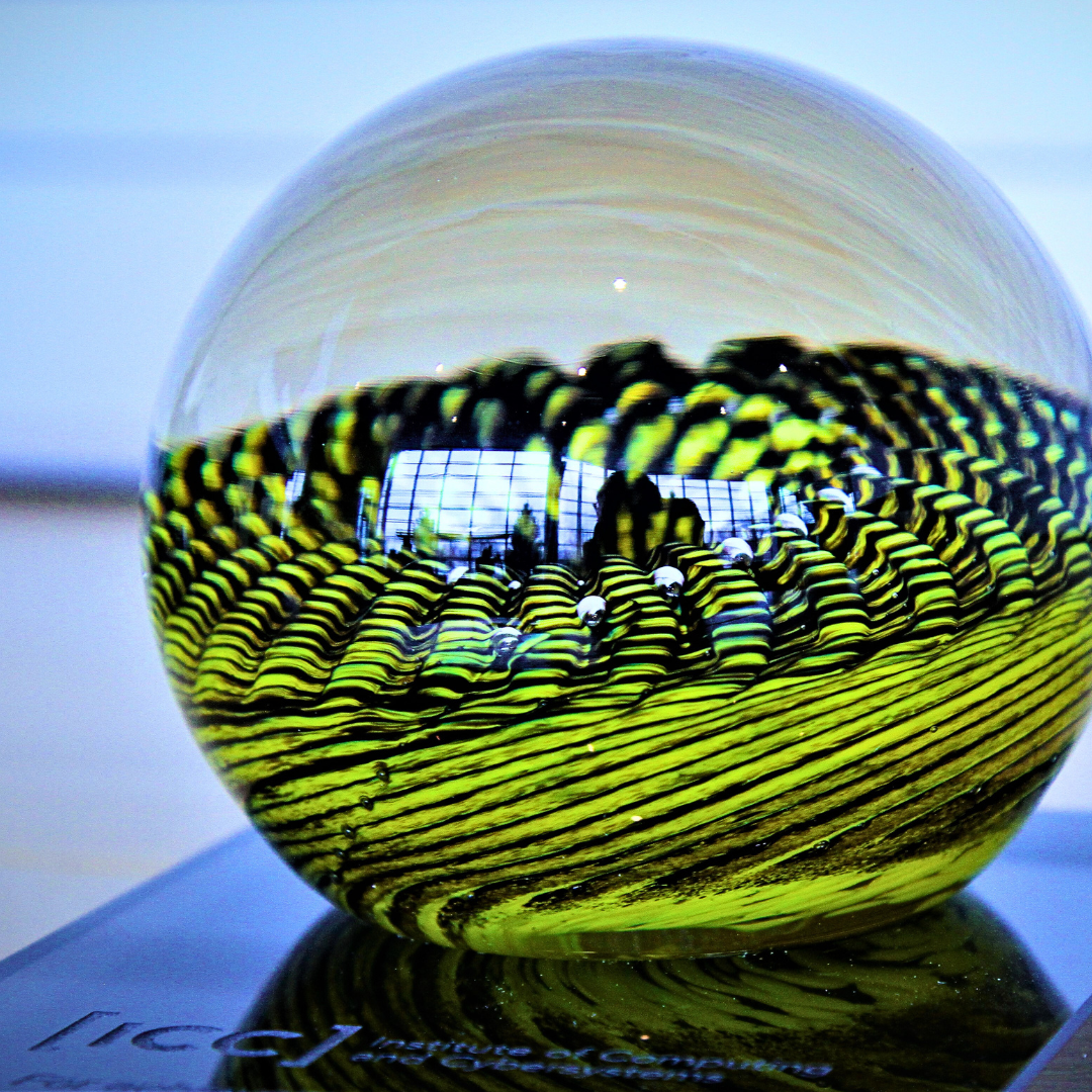 ICC Achievement Award blown glass globe in yellow and black. 
