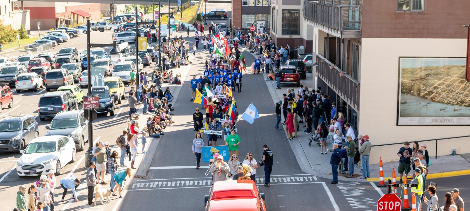 Parade marching through Downtown Houghton