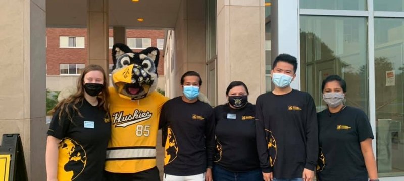 Team of IPS staff members and volunteers to welcome new students to campus, along with Blizzard T Husky