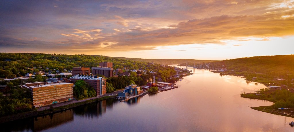 Aerial view of campus including Portage river at sunset