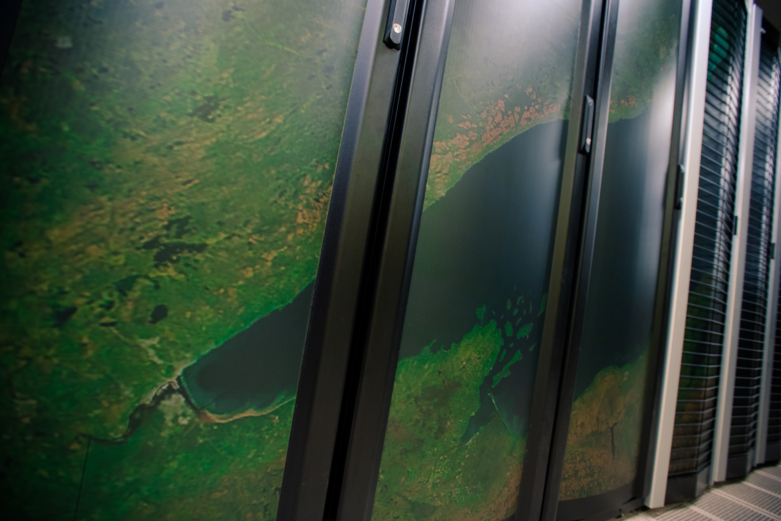 HPC servers at Michigan Tech, shown with an overlaid image, an aerial satellite shot of Lake Superior and the Upper Peninsula