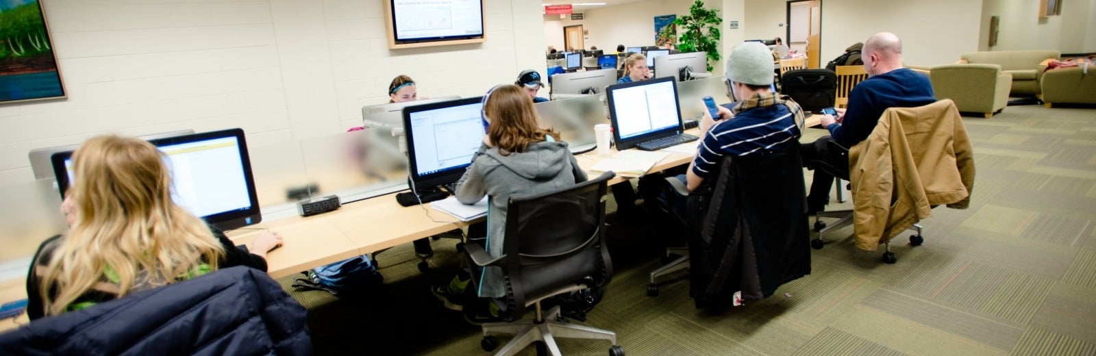 Students work at computer bank in the campus library