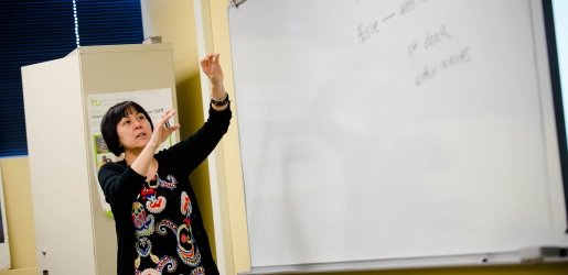 Faculty standing in front of a whiteboard