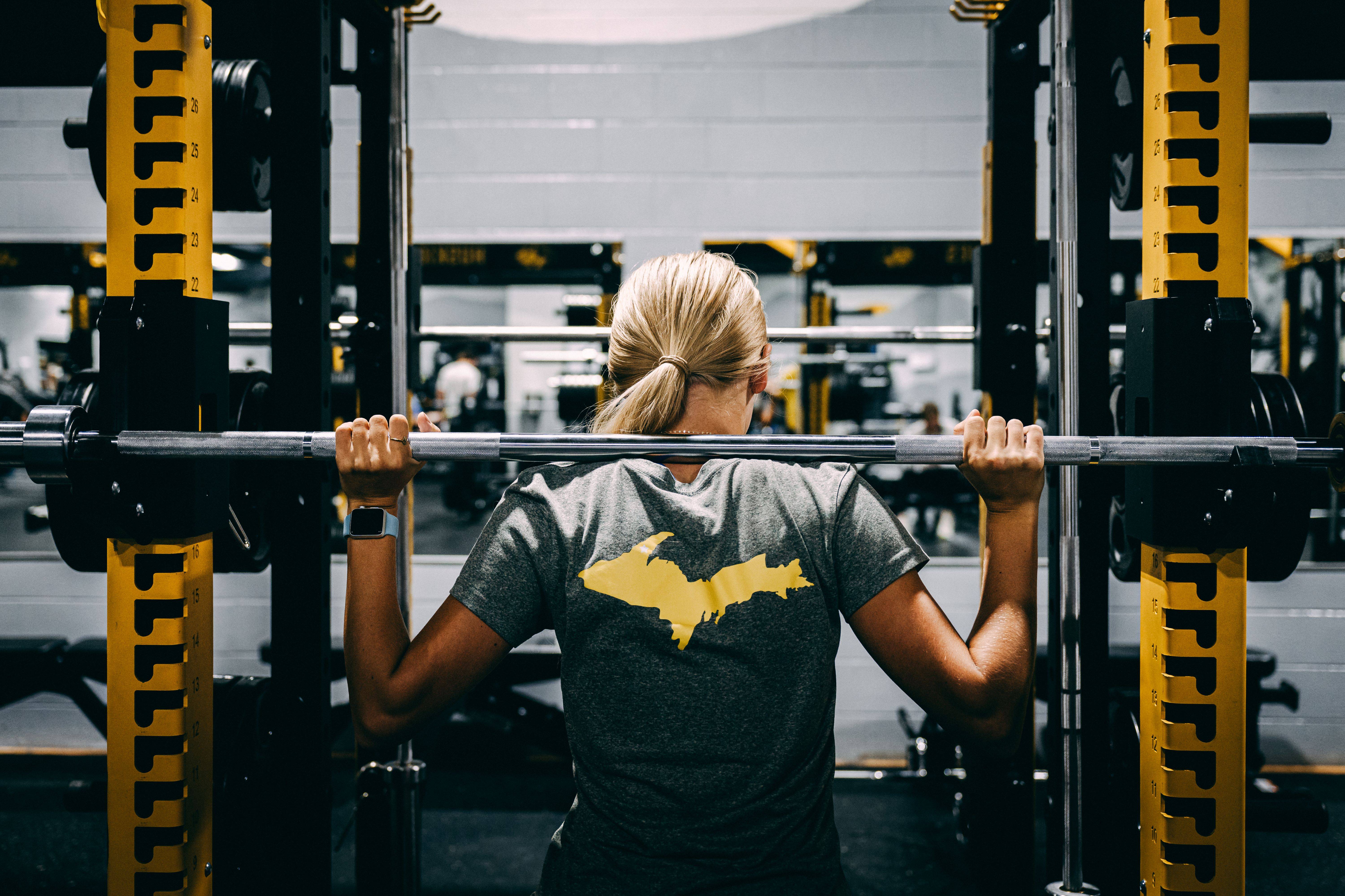 Woman lifting at the squat rack