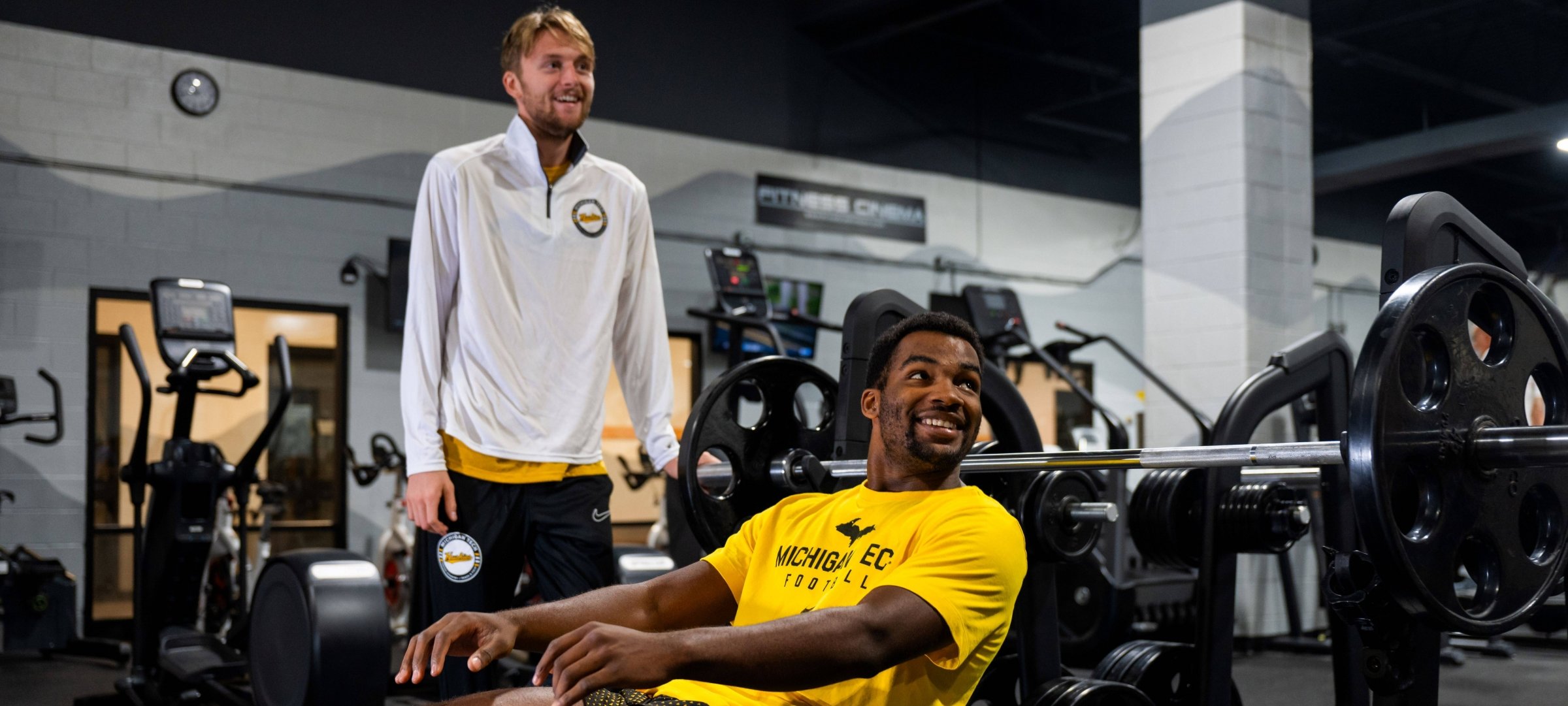 Two male students at the bench press. 