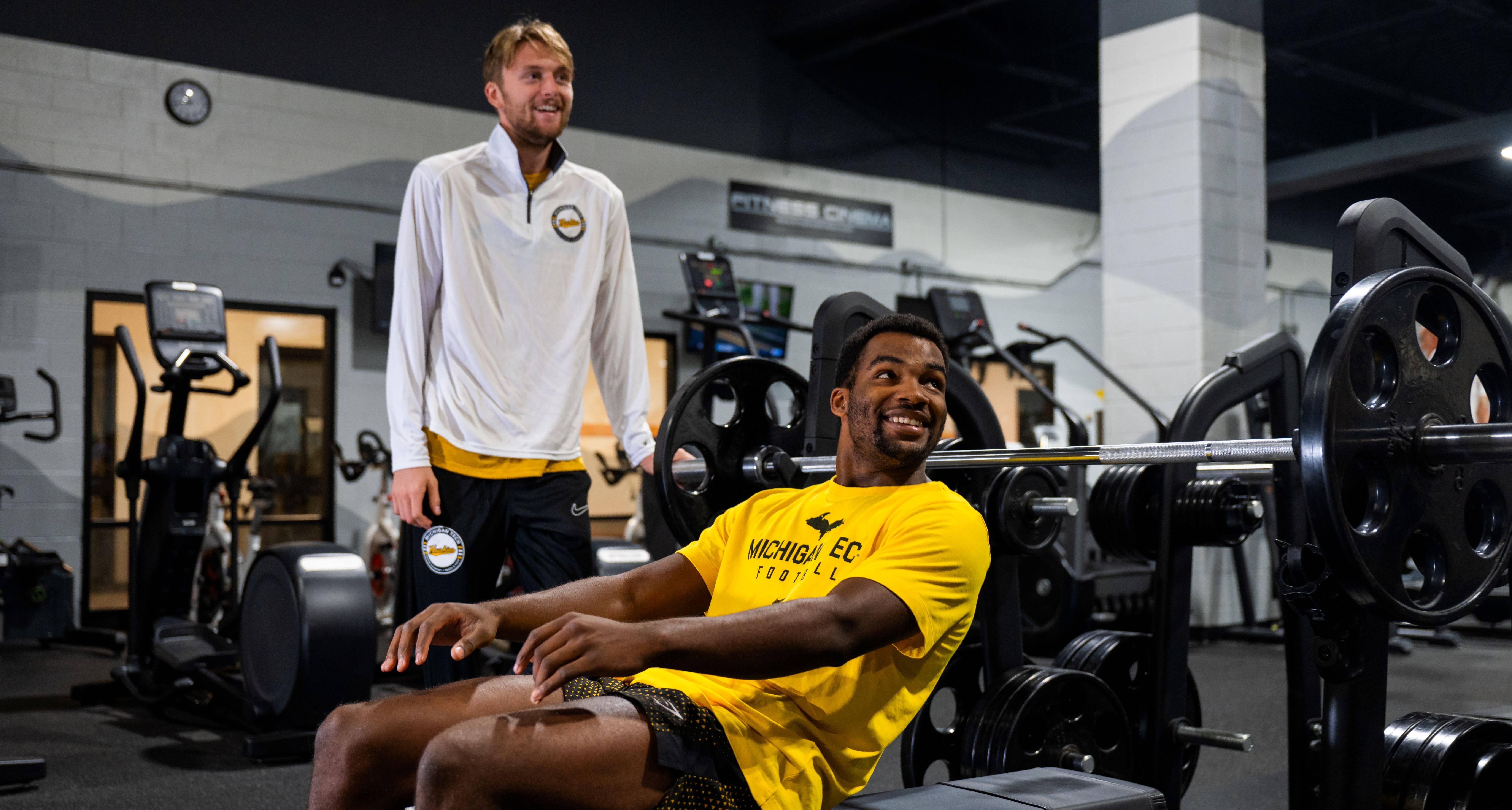 Two male students at the bench press. 