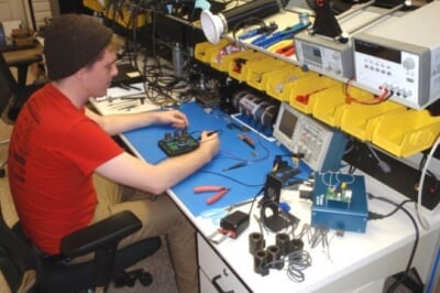 Student working on electrical components Student working on electrical components