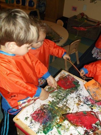 Children painting with flyswatters.