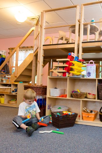 Child playing with toys from a basket.