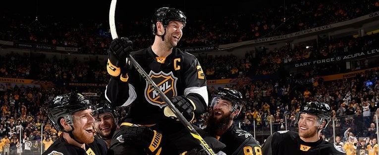 Mark Giordano, Calgary Flames (left) and Brent Burns, San Jose Sharks (right) celebrate John's 2016 NHL All-Star Game MVP award after his two-goal performance.