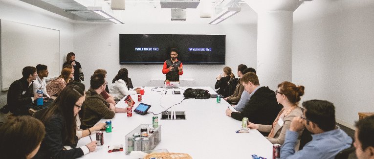 Students in a conference room learning about Twilio.