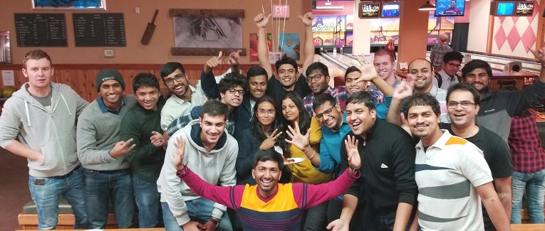 International students group picture in a bowling alley.
