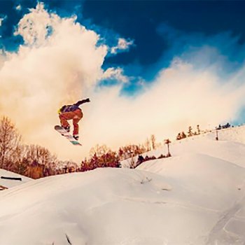 Snowboarder taking a jump at Mont Ripley.