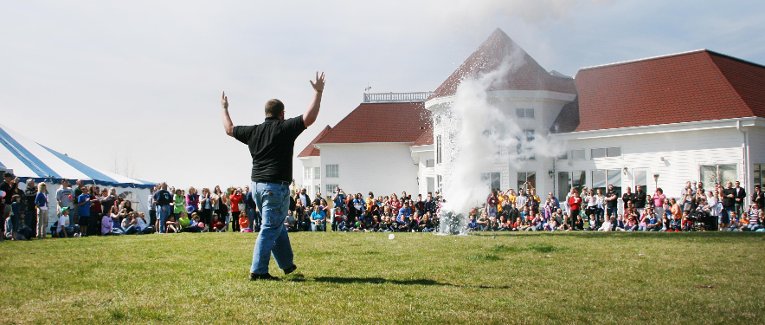 Water and ping pong balls exploding from a plastic garbage can.