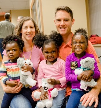 Family with stuffed huskies.