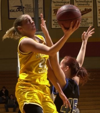 Annie (Madden) Pudelko going up for a shot in front of a defender.