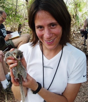 Erika Crook holding up a small lemur.