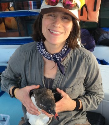 Erika Crook holding a penguin.