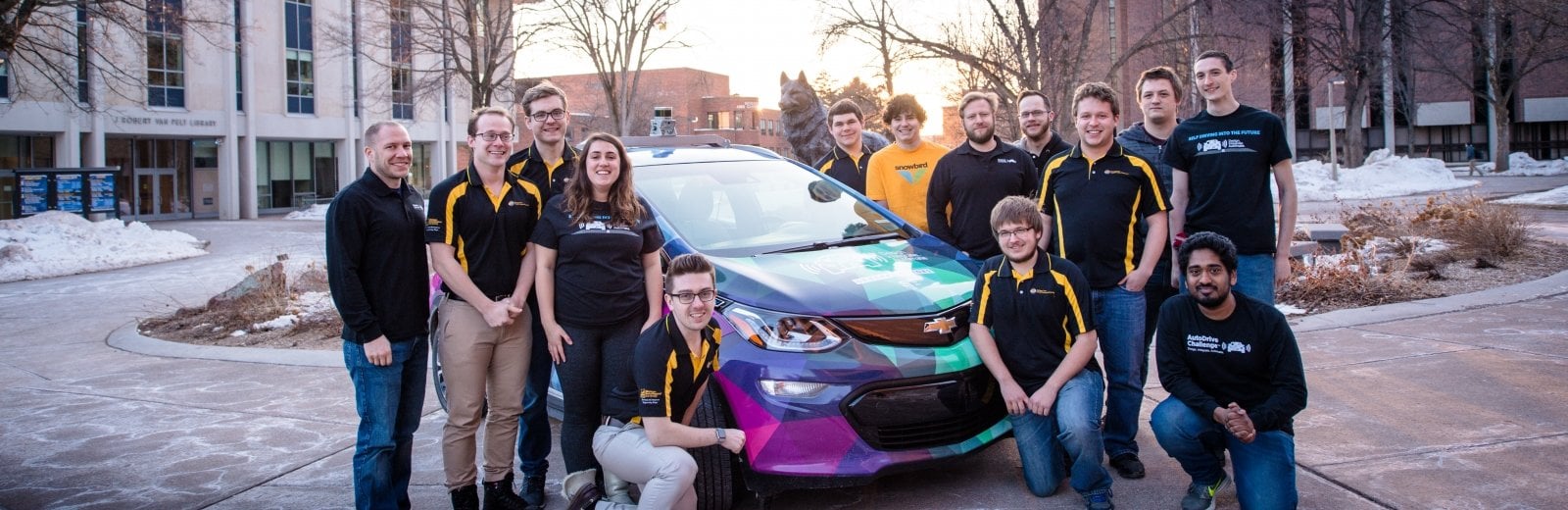 Prometheus Borealis team standing around the car on campus.